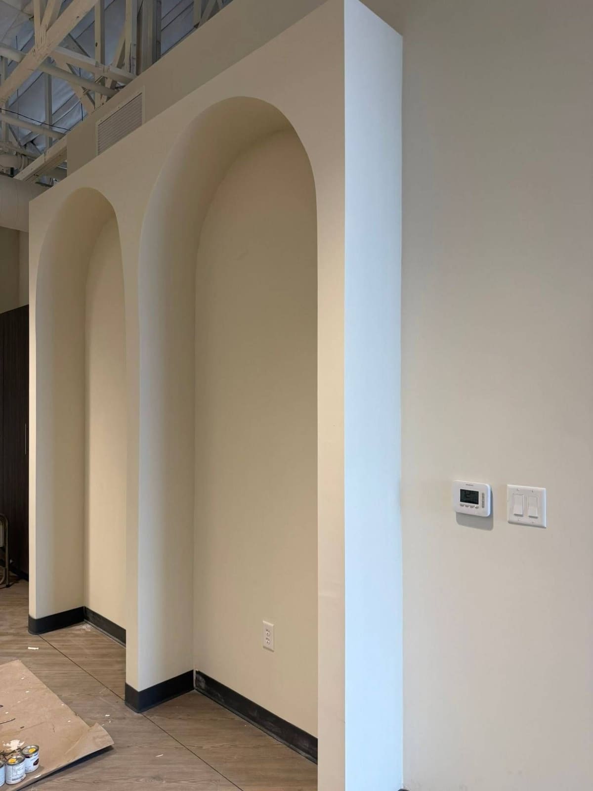 The same two arched wall niches finished and painted in a warm cream color